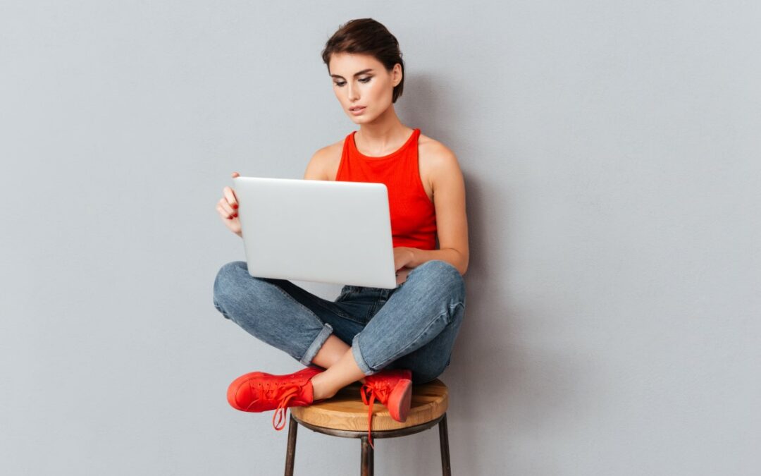Woman blogging on her laptop